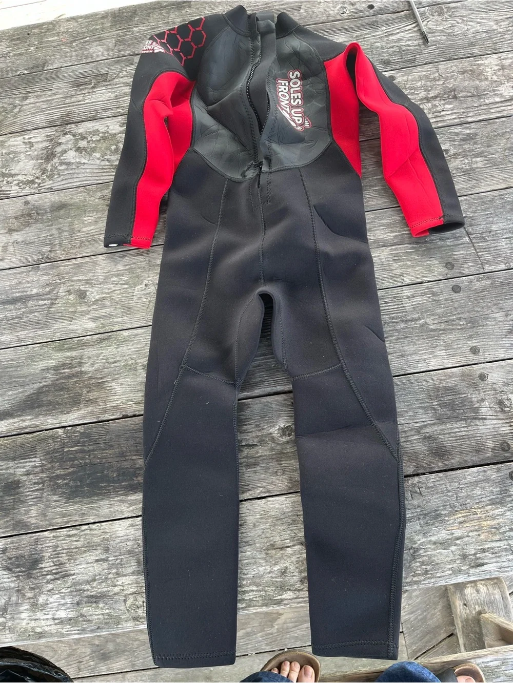 Kids Black and Red Wetsuit -soles up front 10/12 approx